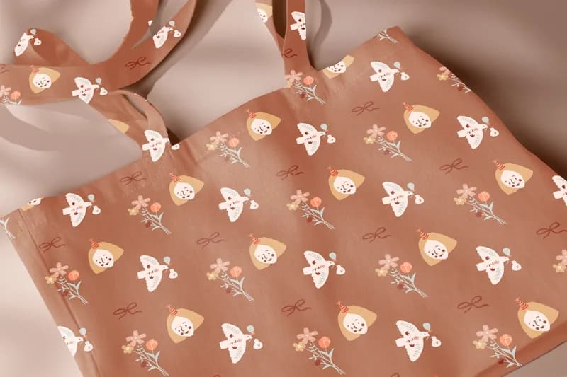 Close-up of a tote bag printed with a bird character pattern in terracotta